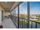 This screened balcony features a ceiling fan and relaxing view of the outdoors at 8711 Blind Pass Rd # 307A, St Pete Beach, FL 33706