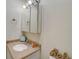 Clean bathroom featuring vanity with cultured marble countertop, mirrored medicine cabinet, and neutral colors at 8711 Blind Pass Rd # 307A, St Pete Beach, FL 33706