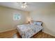 Bright bedroom with coastal themed bedding, wood flooring and a large window at 8711 Blind Pass Rd # 307A, St Pete Beach, FL 33706