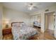 Bright bedroom with coastal themed bedding, mirrored closet doors, and wood flooring at 8711 Blind Pass Rd # 307A, St Pete Beach, FL 33706