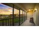 Relaxing screened porch overlooking serene pond with chairs and ceiling fan perfect for enjoying sunsets at 8711 Blind Pass Rd # 307A, St Pete Beach, FL 33706