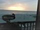Relaxing sunset balcony view overlooking the sandy beach, complete with a welcome sign at 20040 Gulf Blvd # 302, Indian Shores, FL 33785