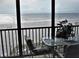 Relaxing balcony view overlooking the sandy beach and ocean, complete with comfortable seating and a welcome sign at 20040 Gulf Blvd # 302, Indian Shores, FL 33785