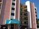 View of Sand Castle III condos with a covered entrance and multiple floors of units with private balconies at 20040 Gulf Blvd # 302, Indian Shores, FL 33785