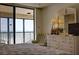 Bright, serene main bedroom featuring a large window with stunning ocean views and a comfortable seating area at 20040 Gulf Blvd # 302, Indian Shores, FL 33785