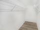 Walk-in closet with wood-look flooring and metal shelving at 3958 Dream Oak Pl # 104, Tampa, FL 33613