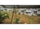 Backyard view with mature landscaping, well-maintained lawn, covered patio, and white picket fence at 4140 55Th N St # 1211, Kenneth City, FL 33709
