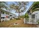An apartment backyard featuring a large tree and white picket fence at 4140 55Th N St # 1211, Kenneth City, FL 33709