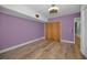 Bedroom showcasing hardwood floors, plenty of wall space, and a closet with a modern ceiling fan at 4140 55Th N St # 1211, Kenneth City, FL 33709