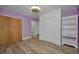 Bedroom showcasing hardwood floors, ample storage space with built-in shelving, multiple closets, and modern ceiling fan at 4140 55Th N St # 1211, Kenneth City, FL 33709
