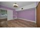 Bedroom featuring hardwood floors, ample wall space, lots of natural light, and a modern ceiling fan at 4140 55Th N St # 1211, Kenneth City, FL 33709
