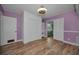 Bedroom featuring hardwood floors, built-in shelving, multiple closets, and modern ceiling fan at 4140 55Th N St # 1211, Kenneth City, FL 33709