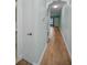 A hallway featuring a stacked washer and dryer and hardwood floors at 4140 55Th N St # 1211, Kenneth City, FL 33709