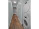 A hallway featuring a stacked washer and dryer and hardwood floors at 4140 55Th N St # 1211, Kenneth City, FL 33709
