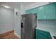 A kitchen featuring stainless steel appliances and light green cabinetry at 4140 55Th N St # 1211, Kenneth City, FL 33709