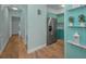A kitchen featuring light green cabinetry, stainless steel appliances, and hardwood floors at 4140 55Th N St # 1211, Kenneth City, FL 33709