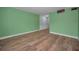 A living room featuring hardwood floors, green walls, and white trim at 4140 55Th N St # 1211, Kenneth City, FL 33709