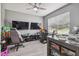 Gaming bedroom featuring a ceiling fan, two monitors, racing chairs, and lots of toys at 451 Hartford Heights St, Spring Hill, FL 34609