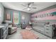 Bedroom with gray walls, pink accents, and light wood-look floors at 451 Hartford Heights St, Spring Hill, FL 34609