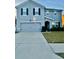 Charming two-story home with a gray facade, well-maintained lawn, and a two-car garage at 451 Hartford Heights St, Spring Hill, FL 34609