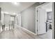 Bright upstairs hallway with modern gray walls and light wood-look floors at 451 Hartford Heights St, Spring Hill, FL 34609
