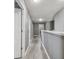 Upstairs hallway with gray walls and light wood-look floors at 451 Hartford Heights St, Spring Hill, FL 34609