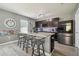 Kitchen with island seating, stainless appliances, and modern lighting fixtures at 451 Hartford Heights St, Spring Hill, FL 34609