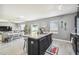 Well-lit kitchen with a view of the living room, complete with a central island at 451 Hartford Heights St, Spring Hill, FL 34609