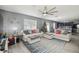 Open living room, light gray walls, ceiling fan, kitchen and dining area in the background at 451 Hartford Heights St, Spring Hill, FL 34609