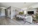 Open-concept living room with gray floors, a ceiling fan, and ample space for furniture at 451 Hartford Heights St, Spring Hill, FL 34609