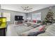 Inviting living room with a large sectional sofa, fireplace and mounted television at 451 Hartford Heights St, Spring Hill, FL 34609