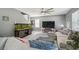 Comfortable living room featuring a large sofa, an aquarium, and a ceiling fan at 451 Hartford Heights St, Spring Hill, FL 34609