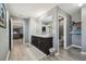 Main bathroom featuring double vanities, with entry into the main bedroom and a water closet at 451 Hartford Heights St, Spring Hill, FL 34609