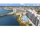 Stunning aerial view of condos with a pool, lush landscaping, and a sandy beach at 6009 Sea Ranch Dr # 303, Hudson, FL 34667