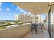 Inviting balcony with seating, offering a beautiful view of lush landscaping and a condo building at 6009 Sea Ranch Dr # 303, Hudson, FL 34667