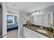 Bathroom with granite countertops, white cabinetry, and decorative coastal-themed accessories at 6009 Sea Ranch Dr # 303, Hudson, FL 34667