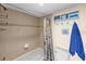 Cozy bathroom with a shower-tub combination and seashell-themed decorations for a beach-themed apartment at 6009 Sea Ranch Dr # 303, Hudson, FL 34667