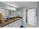 Updated bathroom with stylish vanity, granite countertop, and coastal-themed decor at 6009 Sea Ranch Dr # 303, Hudson, FL 34667
