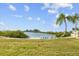 Secluded beach area with colorful lounge chairs under the shade of palm trees at 6009 Sea Ranch Dr # 303, Hudson, FL 34667