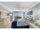 Serene bedroom with ceiling fan, balcony access, and beach-themed decor at 6009 Sea Ranch Dr # 303, Hudson, FL 34667