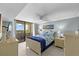 Charming bedroom with a balcony, light blue walls, and white furniture at 6009 Sea Ranch Dr # 303, Hudson, FL 34667