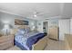 Relaxing bedroom with a ceiling fan, comfortable bed, and beach-themed decor at 6009 Sea Ranch Dr # 303, Hudson, FL 34667