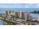Scenic view of a condo complex situated on the water, with lush greenery and tennis courts at 6009 Sea Ranch Dr # 303, Hudson, FL 34667
