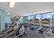 Bright gym featuring treadmills, elliptical machines, and water views at 6009 Sea Ranch Dr # 303, Hudson, FL 34667