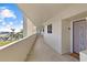 Well-lit condo hallway with a glimpse of the beautiful waterfront view at 6009 Sea Ranch Dr # 303, Hudson, FL 34667