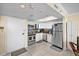 Bright kitchen with stainless steel appliances, white cabinets, and granite countertops under a skylight at 6009 Sea Ranch Dr # 303, Hudson, FL 34667