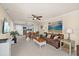 Spacious living area featuring tile floors, comfortable seating, and access to the kitchen at 6009 Sea Ranch Dr # 303, Hudson, FL 34667