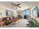 Inviting living room with comfortable seating, a ceiling fan, and sliding glass doors to the balcony at 6009 Sea Ranch Dr # 303, Hudson, FL 34667