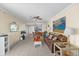 Open living room with tile flooring, ceiling fan, comfortable seating, and access to kitchen at 6009 Sea Ranch Dr # 303, Hudson, FL 34667