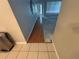 Entryway showcasing tiled flooring transitioning into hardwood and leading to bare concrete in the living space at 10814 Newbridge Dr, Riverview, FL 33579